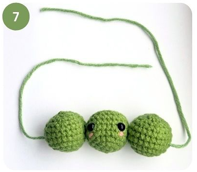 Thread a yarn needle and pass it through all 3 peas