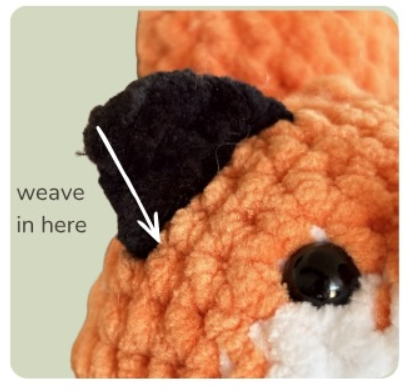 Weave the yarn end through the outside of the ear until you reach the head.