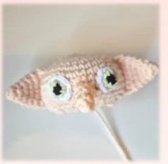 Head with embroidered eyes